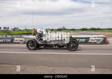 V.S.C.C. Blyton Speed Trials, Blyton Park, Blyton, Lincolnshire, England, UK. Juli 2024. Die Mitglieder des Vintage Sports Car Club (V.S.C.C.) nehmen an der fünften Runde der SpeedTrials-Meisterschaft auf dem Blyton Circuit Teil. Diese eintägige Veranstaltung mit Autos in Aktion, die bereits in den 10er Jahren und bis Ende der 30er Jahre für Sport- und Limousinenwagen hergestellt wurden und vom Austin 7, Frazer Nash, Riley bis hin zu 4,5 Liter Bentleys usw. reichen Diese Veranstaltung wird auf dem langen Kurs durchgeführt, besteht aus kurzen Geraden, schnellen und langsamen Kurven und einer atemberaubenden Haarnadelkurve, die die Fähigkeiten des Fahrers bis ans Limit unter Beweis stellt. Credi Stockfoto