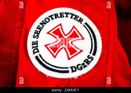 Hooksiel, Deutschland. Juli 2024. Auf einem Patch ist das Logo der Seenotretter zu sehen. Die Deutsche Seeschiffssuche und -Rettung (DGzRS) hält ihren traditionellen Aktionstag am 28. Juli ab. Es wird Demonstrationen, Übungen und Präsentationen an Rettungsstationen an der Nord- und Ostküste geben. Quelle: Sina Schuldt/dpa/Alamy Live News Stockfoto