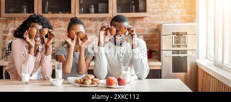 Lustige schwarze Familie eine gute Zeit beim Frühstück in der Küche Stockfoto