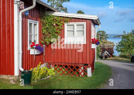 Traditionelles Sommerhaus an einem Sommermorgen im Byfjorden in Bohuslän an der Westküste Schwedens. Stockfoto