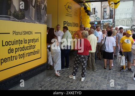 Bukarest, Rumänien. 22. Juli 2024: Während einer Präsidentschaftskampagne von George Simion, dem Kandidaten der rechtspopulistischen und nationalistischen Partei AUR (Allianz für die Union der Rumänen), warten die Menschen auf die Unterzeichnung des "Beitrittsvertrags im Simion-Plan" in seinem Wahlkampfsitz im Bukarest Store. Der "Simion-Plan" zielt darauf ab, den zinsfreien Kauf einer Wohnung ab 35.000 Euro und die Refinanzierung bestehender Hypothekarkredite zwischen 35.000 und 70.000 Euro zu erleichtern, ohne dass Zinsen und andere Kosten vollständig vom Staat subventioniert werden. Quelle: Lucian Alecu/Alamy Stockfoto