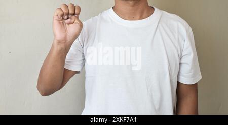 Abgeschnittene Aufnahme eines Mannes, der seine Hand hebt und mit Gebärdensprache den Buchstaben e zeigt Stockfoto