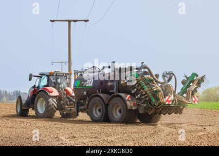 Traktor, der bodennahe Düngemittel ausbringt, um die Umweltverschmutzung durch gasförmiges Ammoniak zu vermeiden, Deutschland, Bayern Stockfoto