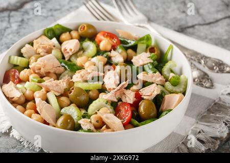 Kichererbsenthunfisch-Salat, gefüllt mit kräftigem Geschmack und frischen Zutaten wie Tomaten, Sellerie, Spinat und hausgemachtem Dressing in einer Schüssel Stockfoto