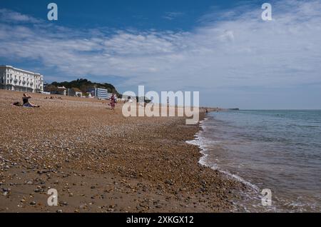 Einheimische genießen einen Nachmittag in der Sommersonne am hastings Beach, East Sussex Stockfoto