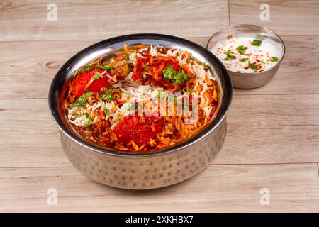 Traditionelles Huhn Dum Biryani mit gemischtem Gemüse serviert mit gemischter Raita, selektiver Fokus Stockfoto