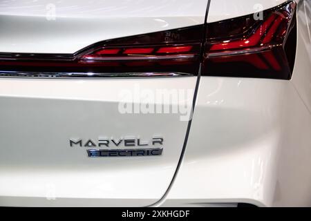 Das Heck-Emblem und die Rückleuchten des White MG Marvel R zeigen das moderne Design und das unverwechselbare Branding des Fahrzeugs mit schlanken, beleuchteten Rückleuchten Stockfoto