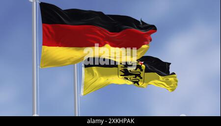 Flagge des Landes Baden-Württemberg winkt mit deutscher Nationalflagge. 3D-Illustrationen rendern. Gewelltes Material. Selektiver Fokus Stockfoto