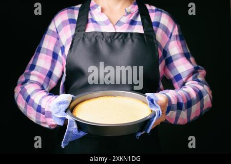 Frisch gebackener Käsekuchen in den Händen einer Frau Stockfoto