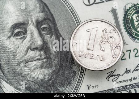 Close Shot 1 Rubel-Münze mit US-100-Dollar-Schein. Wert ca. 1c / 1p. Für Russland Sanktionen, tote Währungen, wertloses Geld. Stockfoto