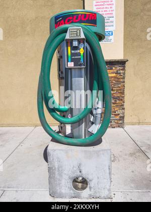 Santa Maria, Kalifornien, USA - 21. Juli 2024. Autowaschanlage mit grünen Schläuchen und Hinweisschild. Stockfoto