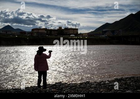 Peking, chinesische Provinz Qinghai. Juli 2024. Liu Yujiao sammelt Proben während einer Expedition, um die Wasserressourcen und die ökologische Umwelt in der Region Sanjiangyuan, nordwestchinesische Provinz Qinghai, am 21. Juli 2024 zu untersuchen. Chinesische Wissenschaftler begannen am 20. Juli eine Expedition, um die Wasserressourcen und die ökologische Umwelt in den Quellgebieten der Flüsse Yangtze und Lancang zu untersuchen. Die Expedition wird wissenschaftliche Untersuchungen zu Flusshydrologie, Wasserökologie, Bodenerosion, Gletschern und Permafrost in Qinghai durchführen. Quelle: Wu Zhizun/Xinhua/Alamy Live News Stockfoto