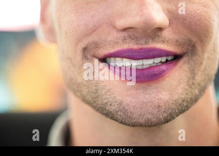 Berlin, Deutschland. Juli 2024. Ein Mann trägt lila Lippenstift. Der 29. Juli ist der Lippenstifttag. Quelle: Hannes P. Albert/dpa/Alamy Live News Stockfoto
