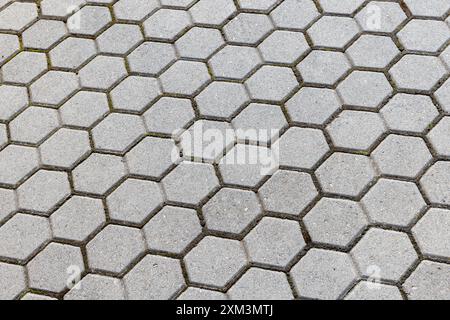 Grauer Betonfliesen Hintergrund, sechseckiges Pflastermuster Stockfoto