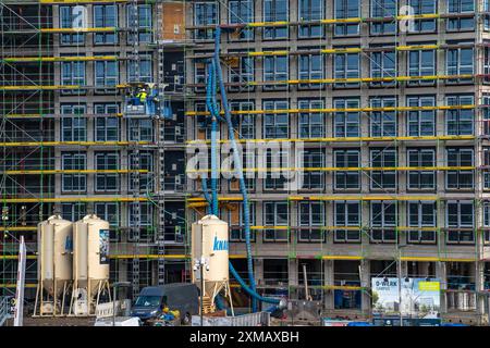 Große Baustelle, Gerüsthülle eines Bürogebäudekomplexes, Luftschläuche für Baulüftung, Heizung, Bauaufzug, O-Werk Stockfoto