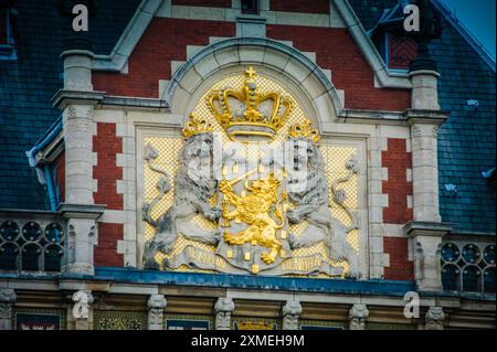 Die Amsterdamer Centraal Station trägt das Wappen der Niederlande. Ein gekrönter Löwe steht stolz und hält ein Schwert und sieben Pfeile. Diese Sym Stockfoto