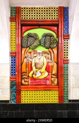 Blick auf eine Mosaikfrieszene eines alten Mannes, der den Koran liest. An der Station Chilanzar der U-Bahn, U-Bahn in Taschkent, Usbekistan. Stockfoto