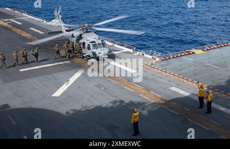 240725-N-PV363-1140 PHILIPPINISCHE SEE (25. Juli 2024) Marines der 31st Marine Expeditionary Unit überqueren das Flugdeck des vorgelagerten amphibischen Angriffsschiffs USS America (LHA 6) während einer VBSS-Übung (Visit, Board, Search and Acquure) während der Routineeinsätze in der Philippinischen See am 25. Juli. America, Leitschiff der America Amphibious Ready Group, ist im Einsatzgebiet der 7. US-Flotte im Einsatz. Die U.S. 7th Fleet ist die größte nach vorne ausgerichtete nummerierte Flotte der US Navy und interagiert routinemäßig mit Verbündeten und Partnern, um eine freie und offene indo- Stockfoto