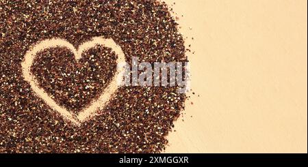 Herz auf verschüttetem Früchtetee gezeichnet, Textur. Blick von oben auf Tee aus Apfel, Zimt, Zitronenschale, Hibiskusblüten, Süßholzwurzel und Nelken. Tee gratis Stockfoto