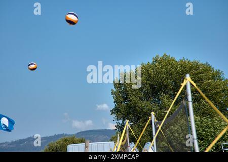 Ein actiongeladener Moment des 3x3 Ladeira Beach Volleyball Turniers in Baiona fängt einen Volleyball ein, der durch die Luft schwingt. Die dynamische Szene hoch Stockfoto