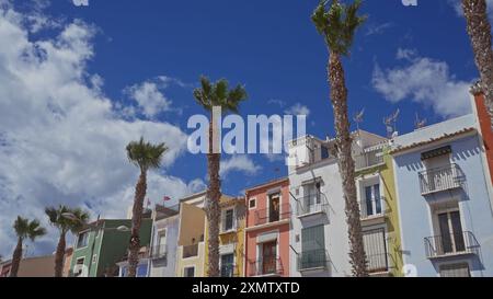 Farbenfrohe spanische Stadt villajoyosa mit Palmen und blauem Himmel Stockfoto