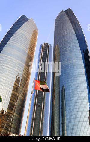 Abu Dhabi, VAE - 27. Februar. 2023: Etihad Towers mit VAE-Flagge mitten in den hohen Gebäuden. Etihad Towers sind eine Gruppe von fünf Gebäuden für O Stockfoto