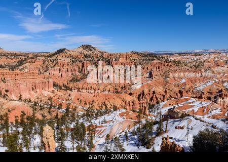 Atemberaubender Blick auf das Amphitheater des Bryce Canyon im Winter mit atemberaubenden Felsformationen, lebhaften Farben und einer dramatischen Schneelandschaft Stockfoto