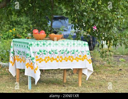 Der Tisch ist mit einer Tischdecke mit Tellern bedeckt Stockfoto