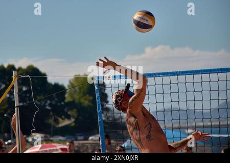 Während des 3x3 Ladeira Beach Volleyball Turniers in Baiona springen die Spieler mit erhobenen Armen und führen einen mächtigen Block in die ne aus Stockfoto