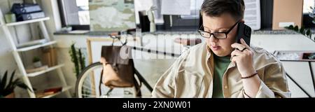 Ein junger Mann mit Down-Syndrom spricht auf einem Handy. Stockfoto