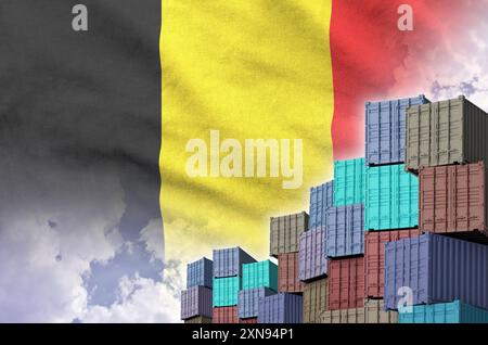 Belgische Flagge und großer Stapel von Frachtcontainern in Docks mit Himmelshintergrund aus nächster Nähe Stockfoto