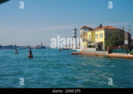 Venedig, Italien, der Leuchtturm von Murano, türkisfarbenes Wasser und ein gelbes Haus mit Blick auf die Lagune Stockfoto