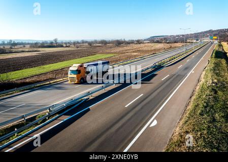 Müllwagen entlang der Stadtautobahn bei Sonnenuntergang mit schönem klaren Himmel Stockfoto