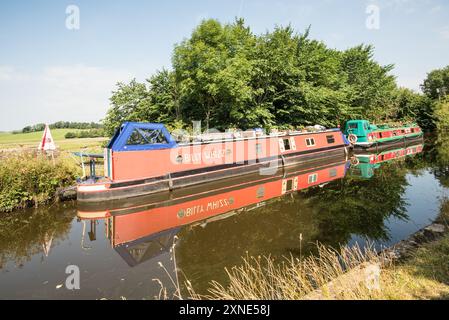 Farbenfrohe Schmalboote Billy Whizz (links) und Wildflower (rechts), Leeds & Liverpool Canal in der Nähe von Gargrave 1. August 2024 Stockfoto