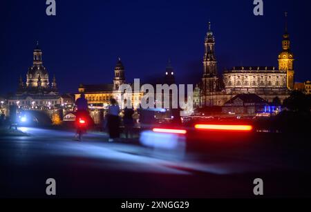 Dresden, Deutschland. 31. Juli 2024. Am Abend sind Fußgänger und Radfahrer auf dem Elbradweg vor der historischen Altstadt mit der Frauenkirche (l-r), dem Ständehaus, dem Rathaus, der Hofkirche und dem Hausmannsturm unterwegs. Robert Michael/dpa/Alamy Live News Stockfoto