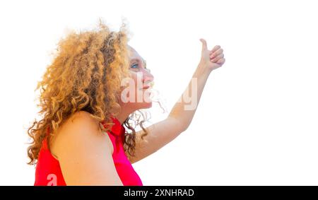 Porträt Happy Fasion Woman zeigt den Daumen nach oben gegen den Himmel und schaut seitlich und nach oben Stockfoto