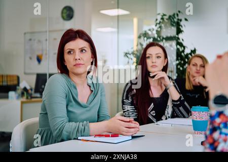 Diverse Geschäftsteams diskutieren Projekte in einem modernen Glasbüro. Stockfoto