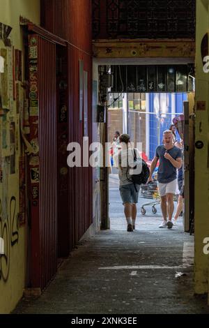 Die Menschen laufen entlang der Bussey Alley, die vom Copeland Park in Peckham, South London, zur Rye Lane führt. Stockfoto