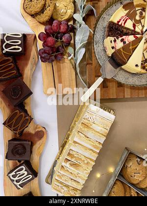 Verschiedene Desserts, darunter Kekse, Kuchen und Trauben auf einem Holz Stockfoto