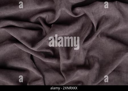 Grauer Hintergrund aus zerknittertem Textilgewebe. Stockfoto
