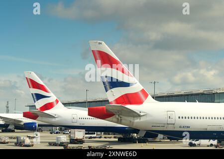 London, England, UK - 29. April 2024: Heckflossen von Passagierflugzeugen der Boeing 777, die von British Aiirways am Flughafen London Heathrow betrieben werden. Stockfoto