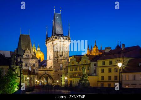 Beleuchteter Brückenturm der Kleinstadt, Nikolaikirche und Prager Burg in der Dämmerung, UNESCO-Weltkulturerbe, Altstadt, Prag, Tschechische Republik Stockfoto