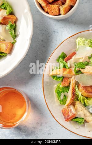 Chicken Caesar Salat mit Wein, über dem Kopf flache Lay Shot von zwei Tellern Stockfoto