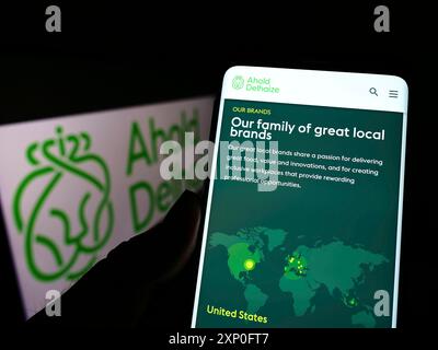 Stuttgart, Deutschland, 03-06-2022: Person, die ein Handy hält, mit Webseite des niederländischen Unternehmens Koninklijke Ahold Delhaize N.V. auf dem Bildschirm mit Logo. Konzentrieren Sie sich auf Stockfoto