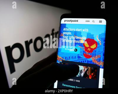 Stuttgart, Deutschland, 15.01.2022: Person mit Smartphone und Website des US-amerikanischen Sicherheitssoftware-Unternehmens Proofpoint Inc. Auf dem Bildschirm mit Logo. Konzentrieren Sie sich auf Stockfoto