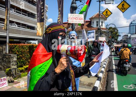 Bandung, West-Java, Indonesien. August 2024. Künstler, die Mitglieder des Bandung Spirit of Palestine sind, halten Plakate während eines Protestes am Global Solidarity Day for Gaza am Dasasila Monument in Bandung, West Java. Der Protest, der zeitgleich mit dem 300. Tag des israelischen Völkermords in Palästina stattfand, forderte ein Ende des israelischen Massakers an Palästinensern und die sofortige Einreise der Hilfe in Palästina und drückte sein Beileid für die Ermordung des Hamas-Führers Ismail Haniyeh aus. (Kreditbild: © Dimas Rachmatsyah/ZUMA Press Wire) NUR REDAKTIONELLE VERWENDUNG! Nicht für kommerzielle USA Stockfoto