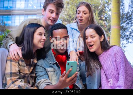 Schüler, die Spaß mit Mobiltelefonen haben, um Inhalte in sozialen Medien zu erstellen. Stockfoto