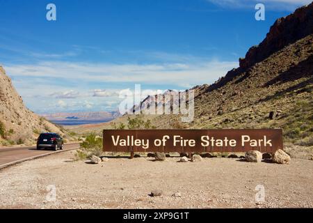 Eintrittsschild zum Valley of Fire State Park mit aussicht und einem Fahrzeug auf einem Roadtrip. Nevada, USA Stockfoto