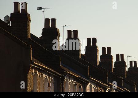 Dateifoto vom 19./01/16 von Schornsteinen auf einer Reihe von Reihenwohnhäusern im Südosten Londons. Terrassenhäuser mit zwei Schlafzimmern sind nach wie vor der am schnellsten verkaufte Immobilientyp in England und Wales und fliegen laut Website Zoopla in weniger als einem Monat aus den Regalen. Ausgabedatum: Montag, 5. August 2024. Stockfoto