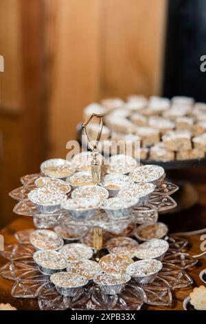 Mini-Puderzucker-Desserts auf einem mehrstufigen Stand. Stockfoto